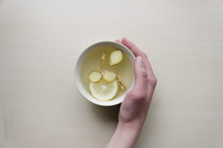 Person Holding White Bowl With Sliced Lime And Ginger Inside Scaled.jpg