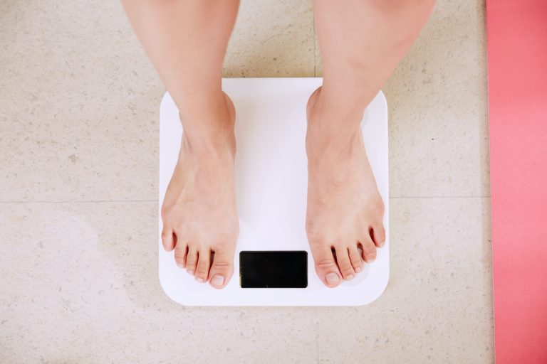 Person Standing On White Digital Bathroom Scale 1 Scaled.jpg