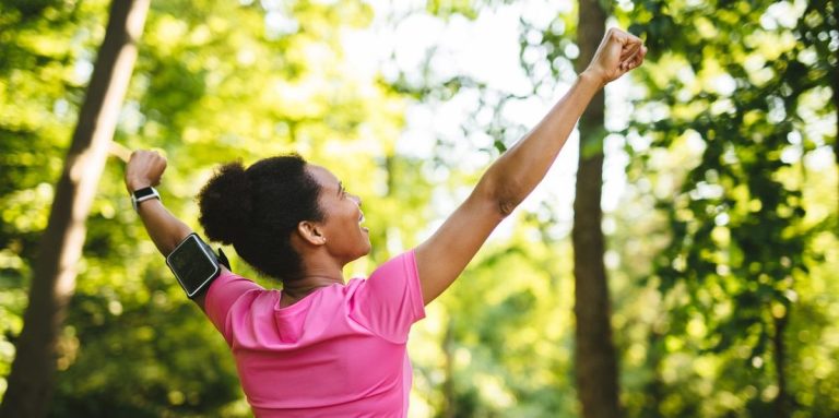 Woman Celebrating With Arms Raised After Workout Outdoors.jpg