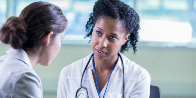 A Compassionate Female Doctor Sits Across From A Patient And Listens To Her Story.jpg