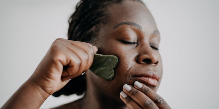 Woman Doing Gua Sha On Her Face.jpg