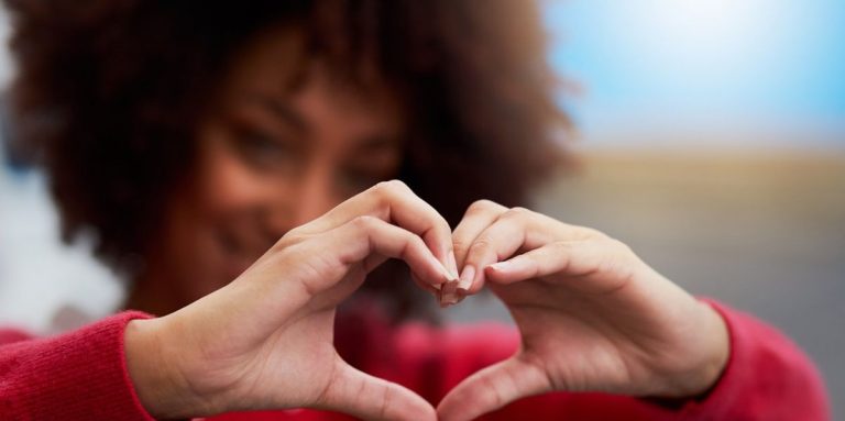 Woman Forming A Heart Shape With Her Fingers.jpg