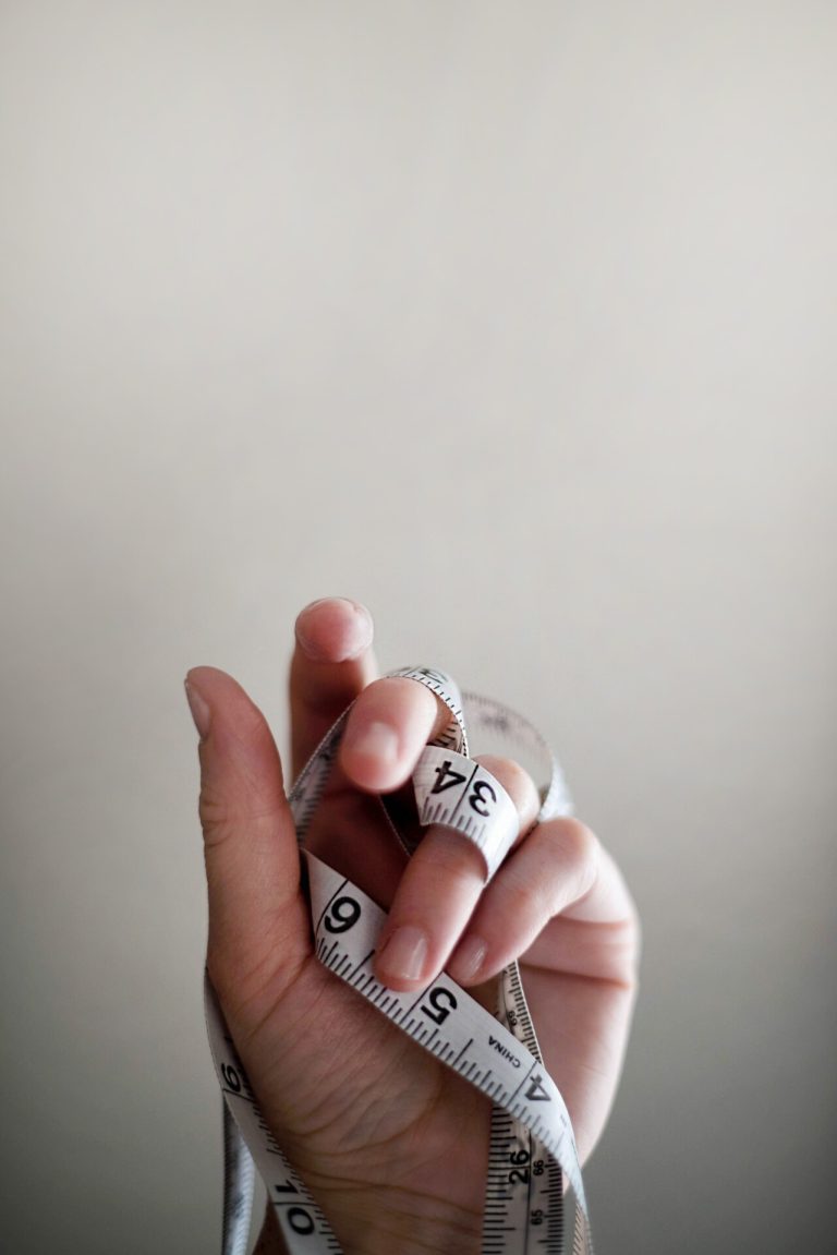 Persons Left Hand Wrapped By Tape Measure.jpg