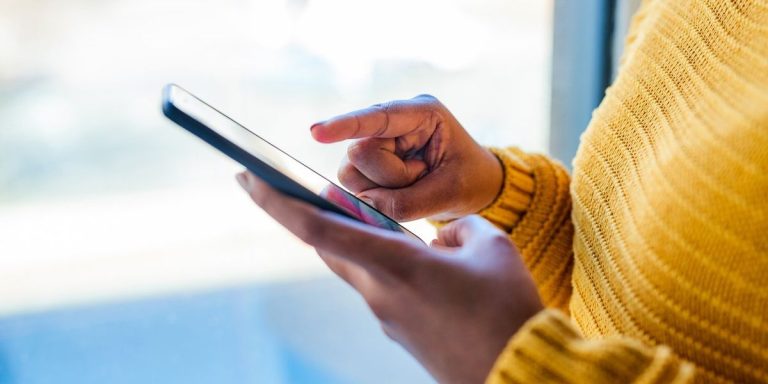 Woman Using A Mobile Phone Indoors.jpg