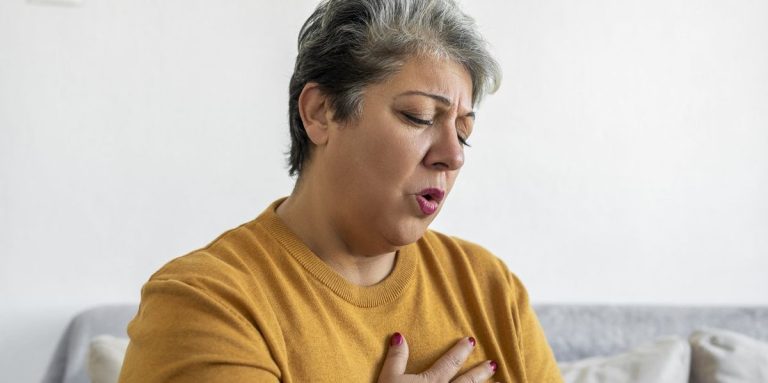 Woman Hand Holding Chest Pain Difficulty To Breathe.jpg