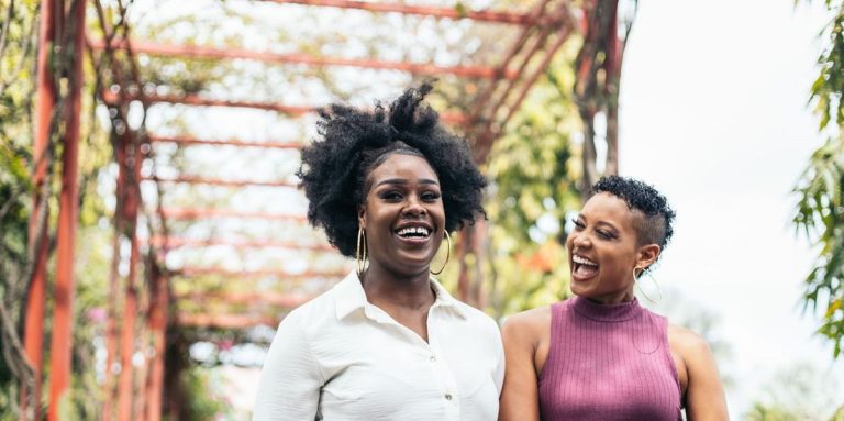 Women Stylish Friends Having Fun Walking In A Park.jpg