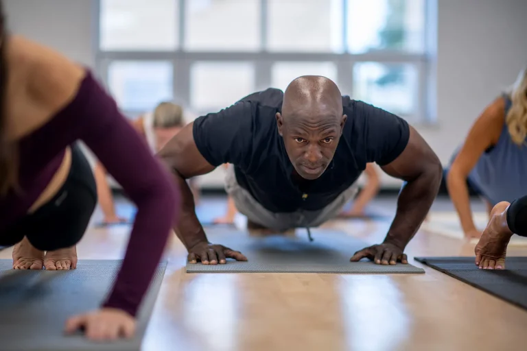 1800ss Getty Rf Man Doing Pushups In Class.jpg