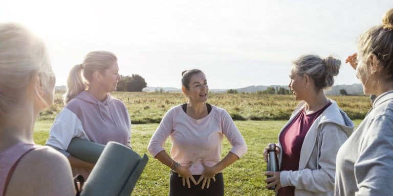 Group Of Mature Women Doing Yoga Outdoors.jpg