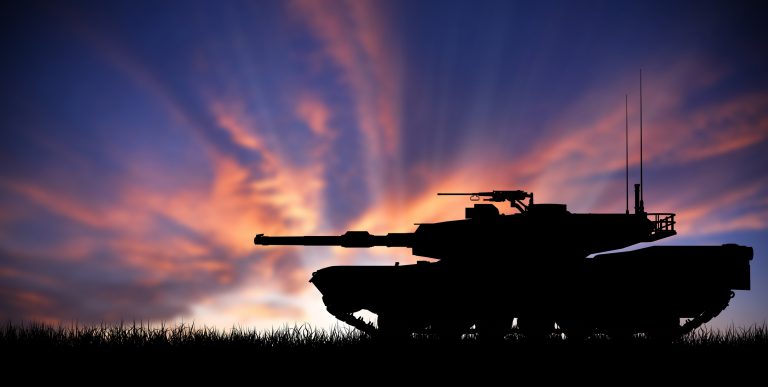 M1 Abrams Main Battle Tank Silhouetted Against A Sunset.jpg