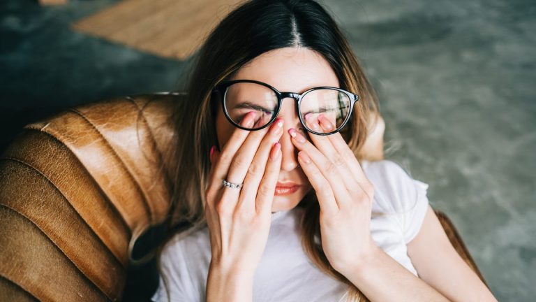 Person With Glasses Rubbing Eyes.jpg