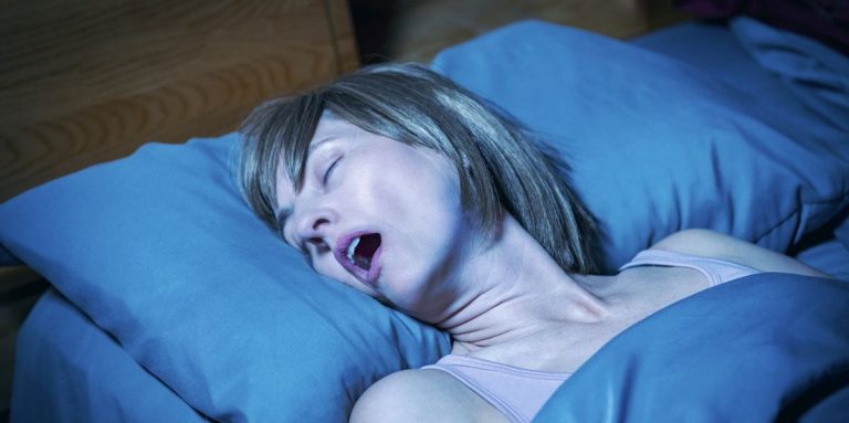 Woman In Bed At Night With Her Mouth Open Snoring Obnoxiously.jpg