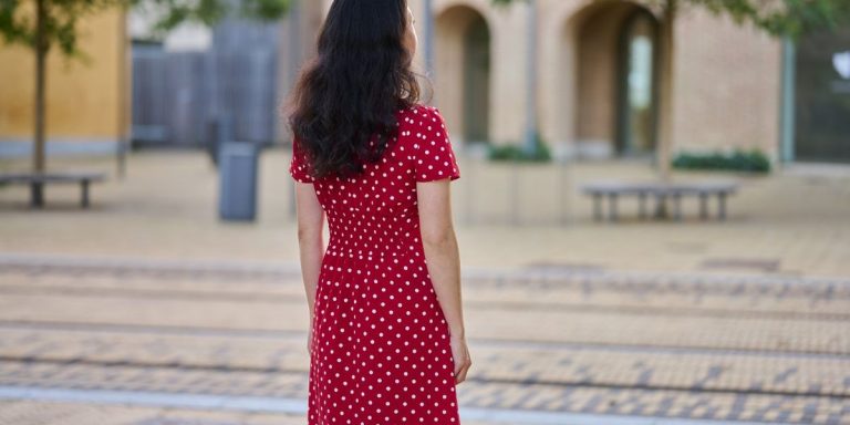 Woman Outdoors In The City Wearing Red Dress Full Length Portrait Rear View.jpg